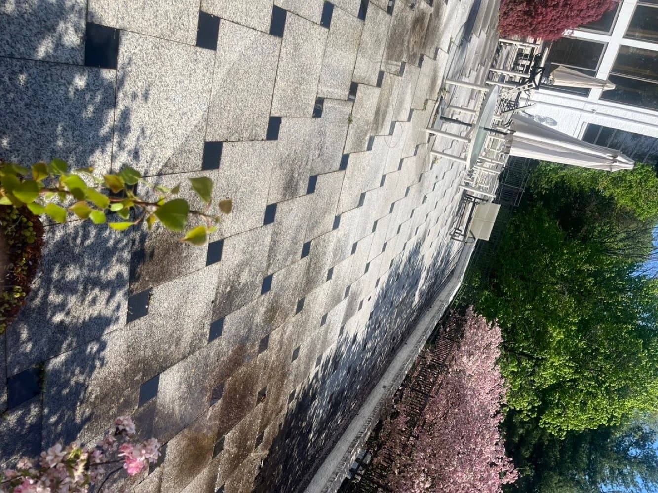 Stone paver patio darkened by dirt and mildew before cleaning