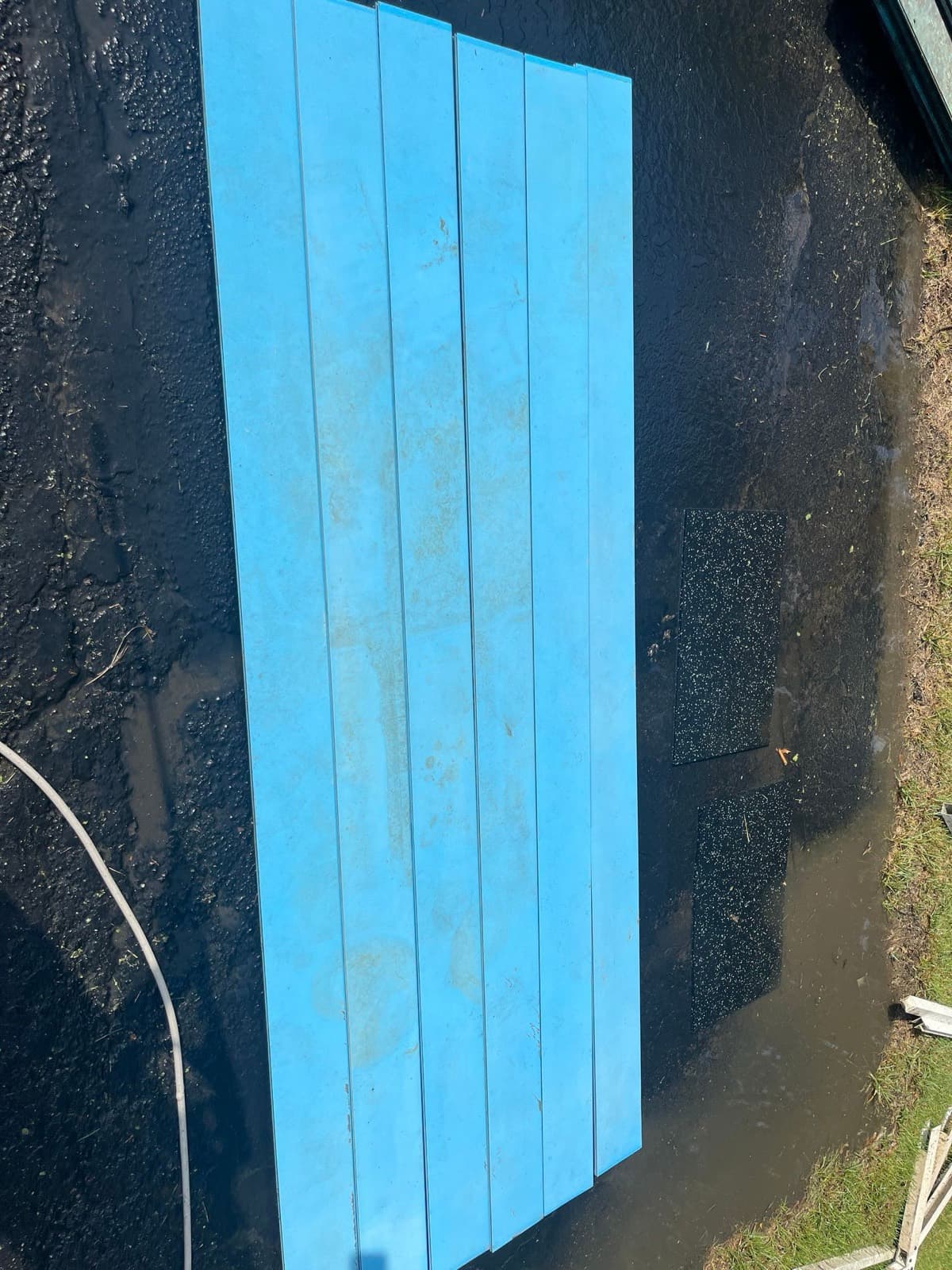 Same picnic table in clean solid blue after washing and refinishing