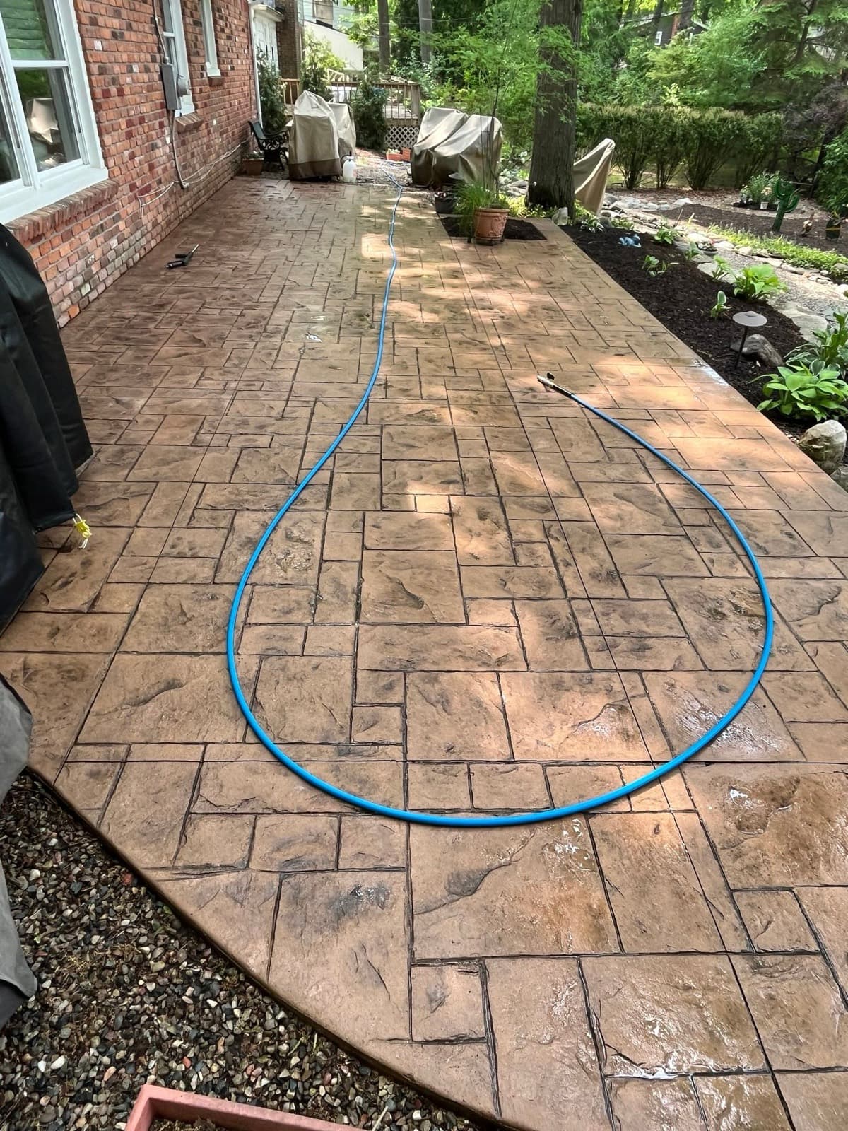 Stamped concrete patio with rich color restored after cleaning and sealing